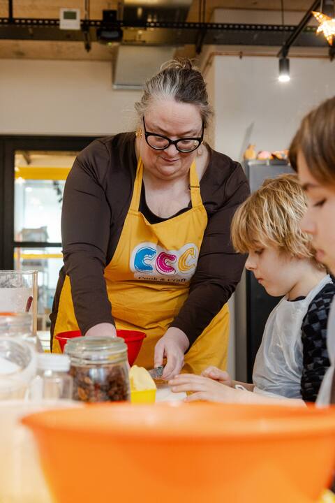 Joanna makes scone dough while two children look on