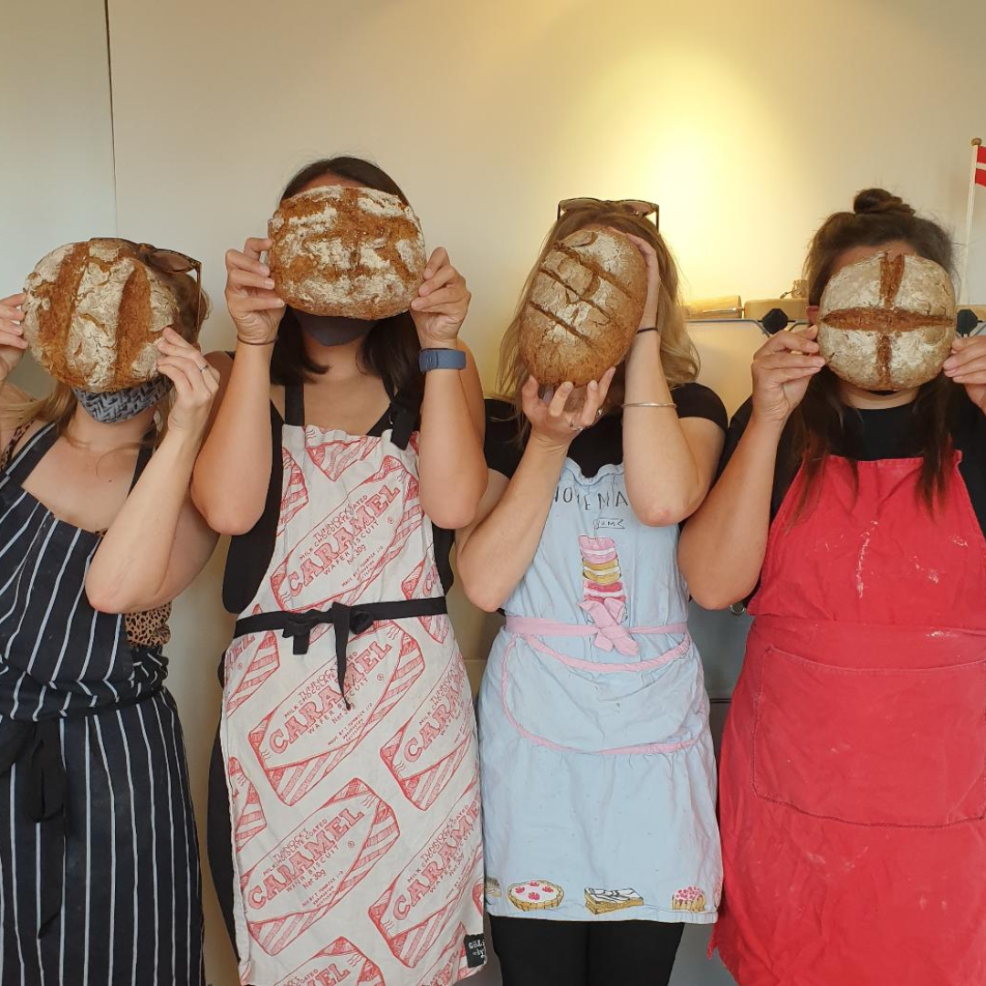 4 white women are holding up the bead they made at the Cook and Craft bread making workshop