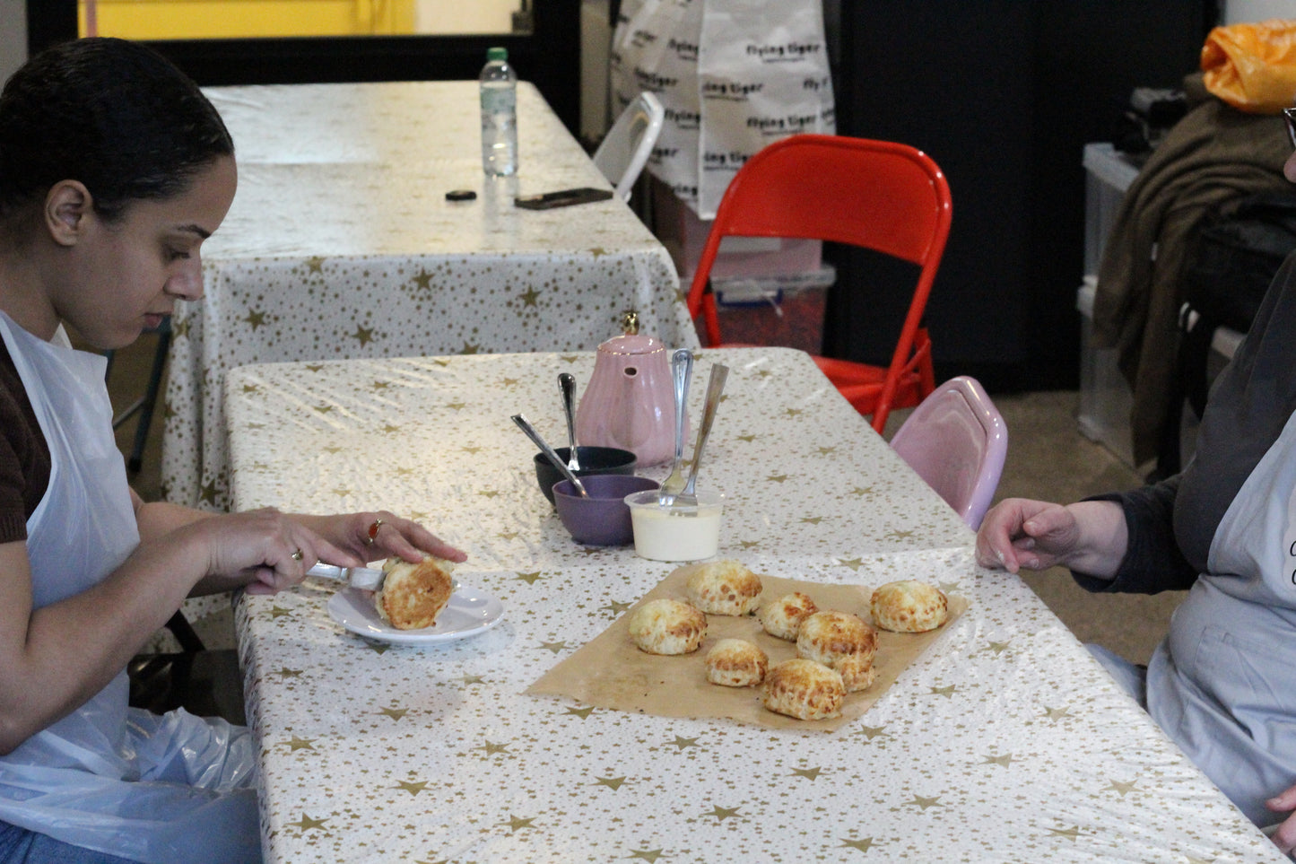 A woman cuts open one of her freshly baked scones