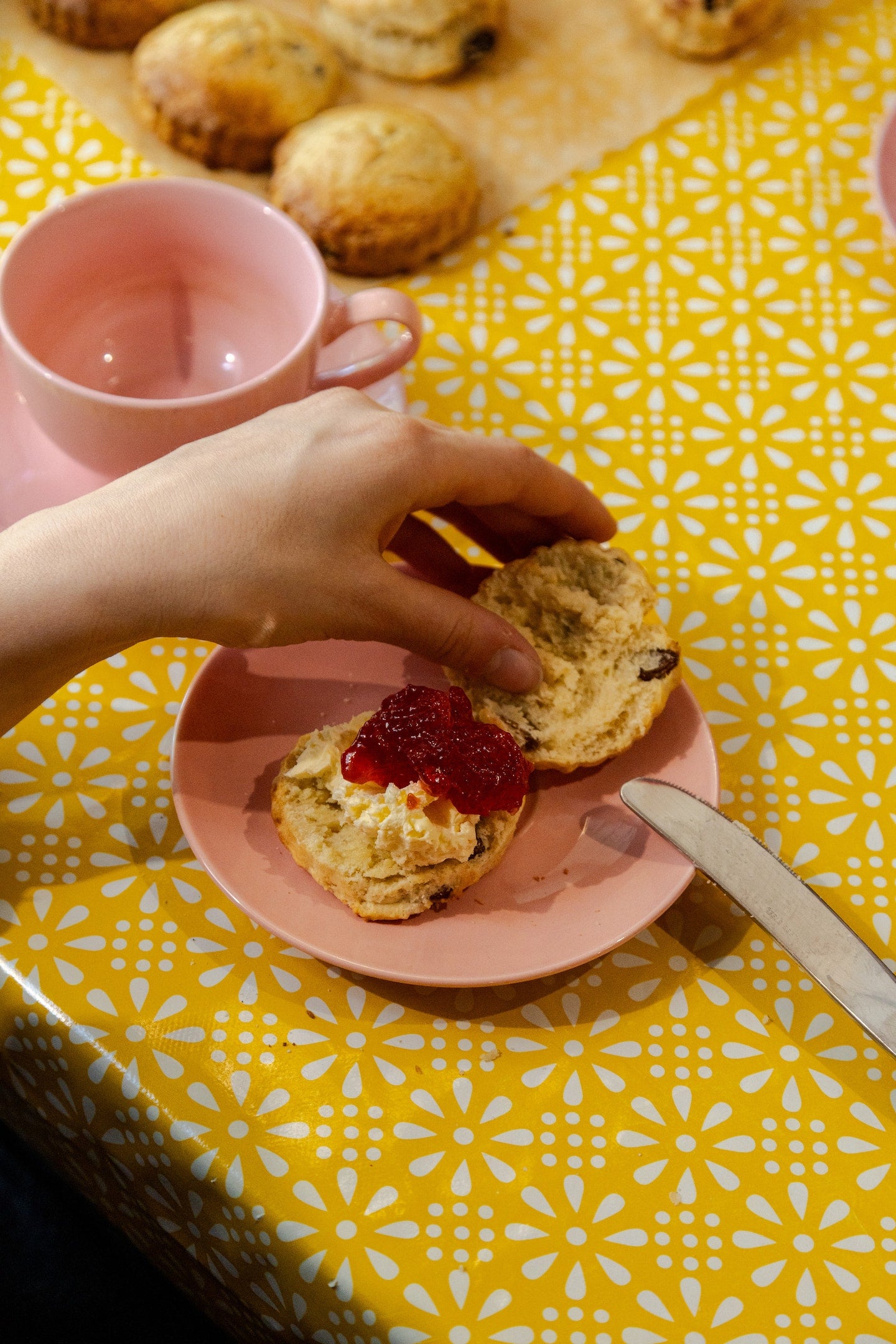 A scone topped in the Devonian style - with clotted cream first and jam on top