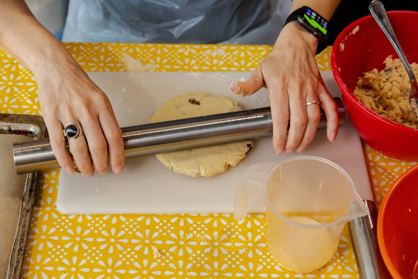 A woman rolls out the dough